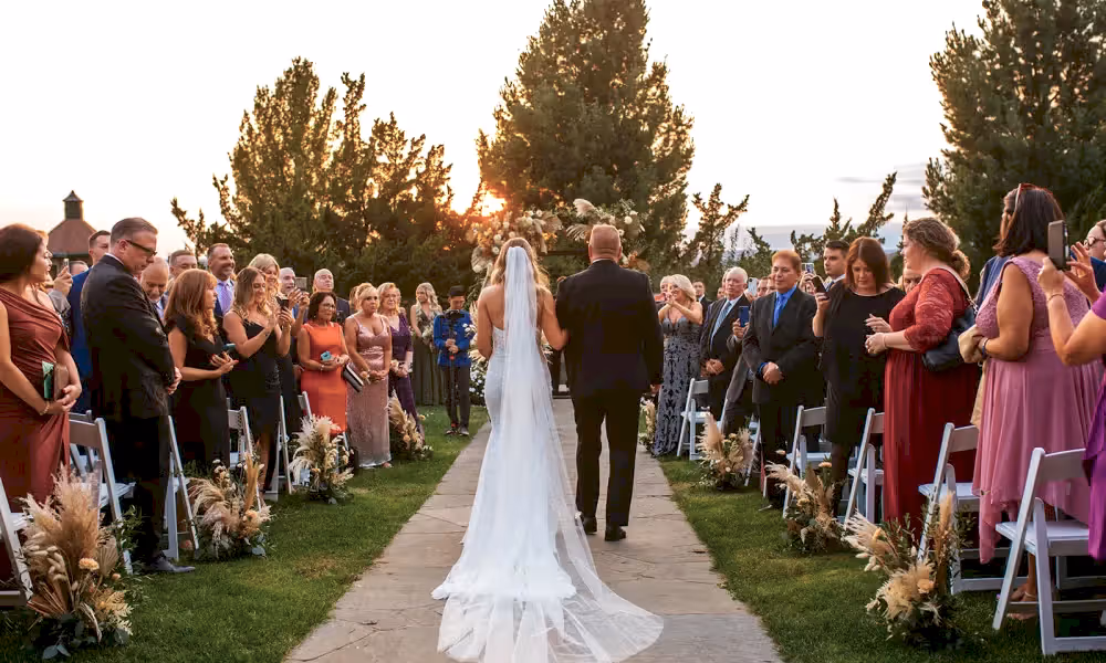 Bride walking down the aisle at Wedding Garden ceremony space at Crystal Springs Country Club. 