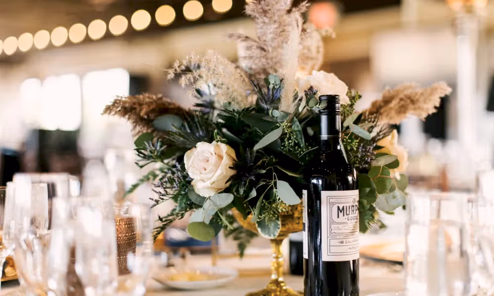 Flowers on table with wine during a Ballyowen Bailigh Bluff House wedding reception.