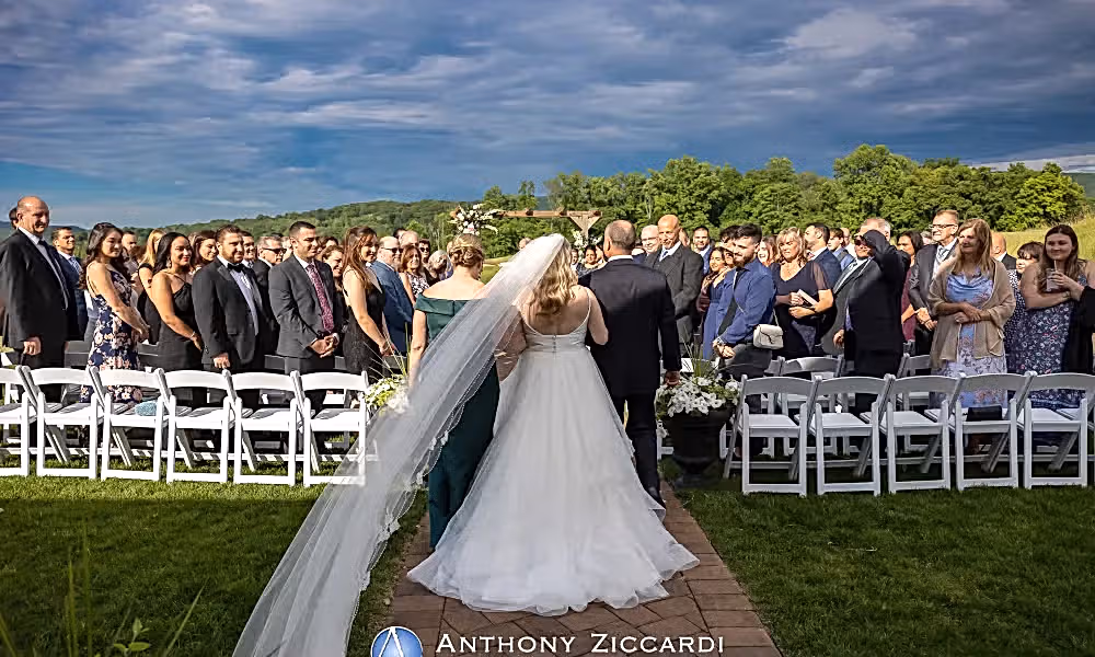 Bride walks down aisle with mother and father during her Ballyowen wedding garden ceremony. 