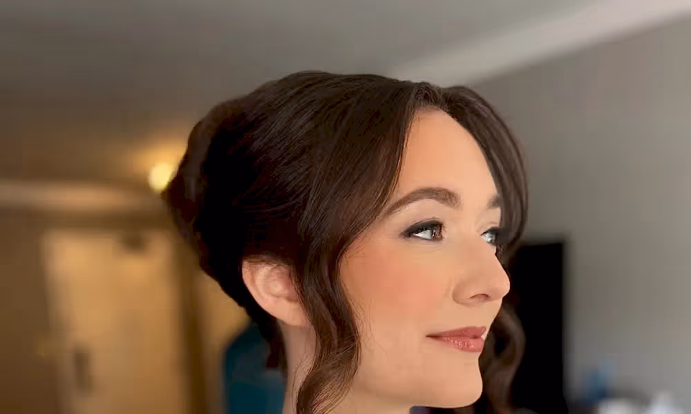Side profile of woman with updo hairstyle. 