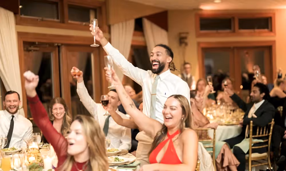 Guests cheerings champagne at Black Bear wedding reception.