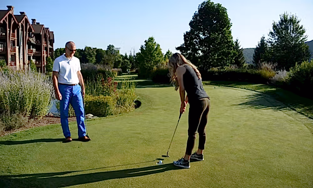 A couple enjoying a weekend getaway and golfing on the putting course at Crystal Springs Resort