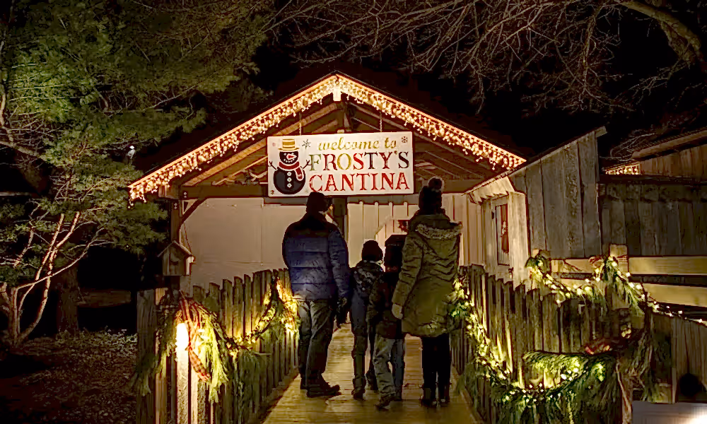 Family standing in front of Frosty's Cantina sign.