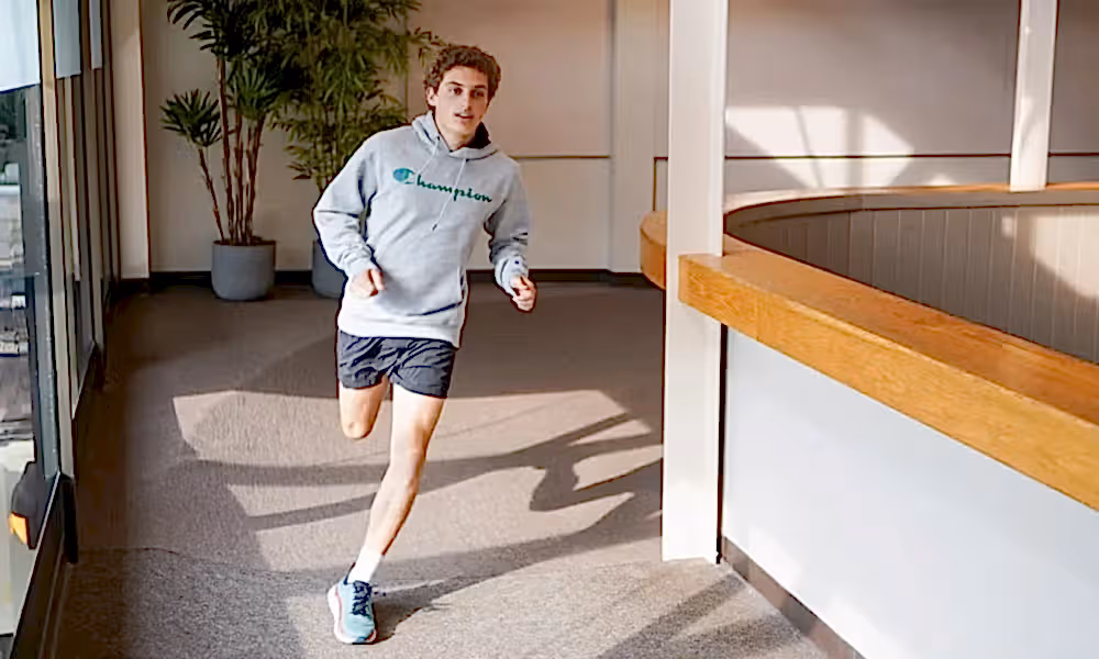 Man running on indoor running track at Minerals Sports Club.