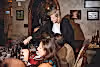 Susanne Wagner pouring a glass of wine for guests dining in wine cellar.